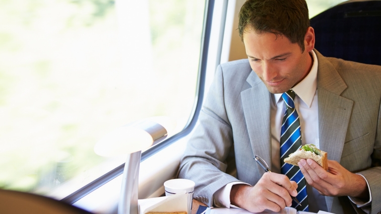 bussinessman-eating-sandwich-train-journey