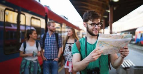 traveling_friends_at_train_station_with_map_-_mobile