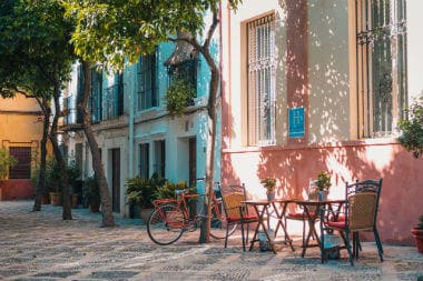 A quiet street with tables for a cafe in Seville