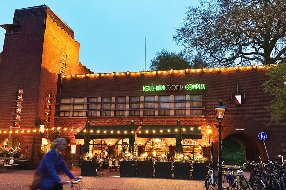 Night shot of the Louis Hartlooper Complex in Utrecht, with its ambient lights glowing warmly.