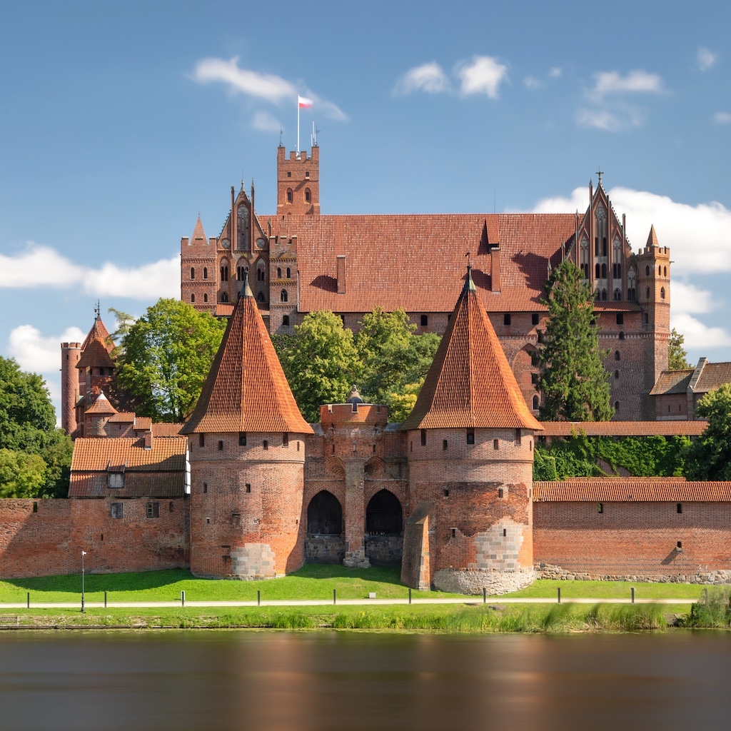 The majestic red brick Malbork Castle by the Nogat River