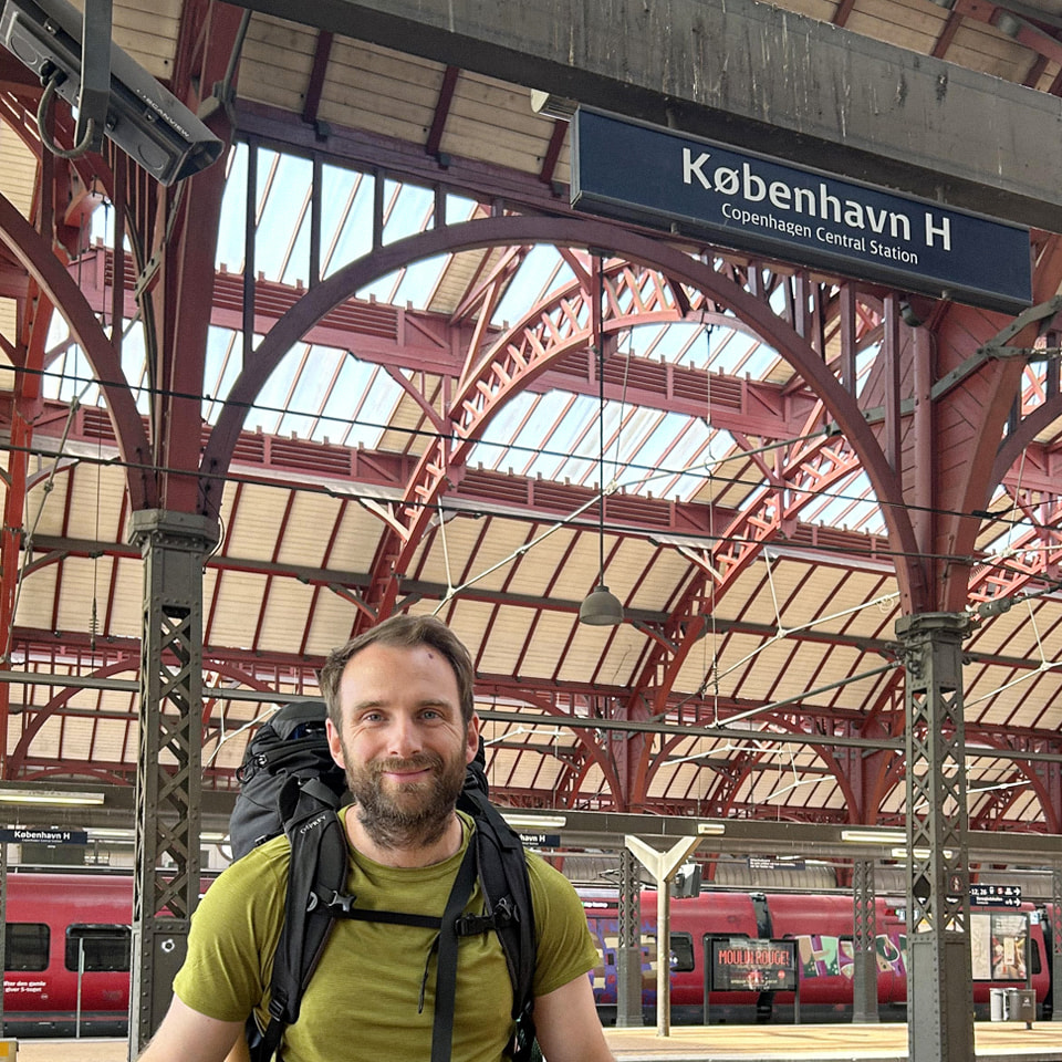 A man stands on a train platform