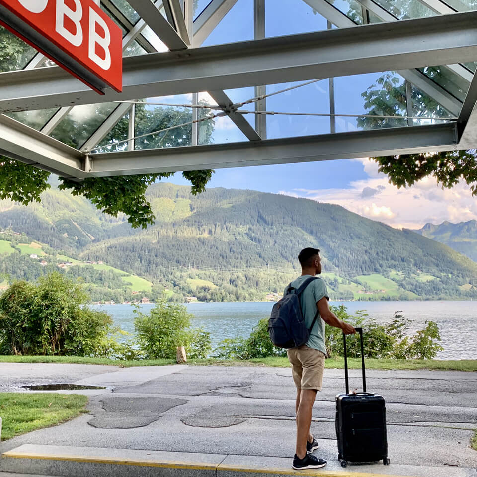 Bart stands on a train platform near a lake